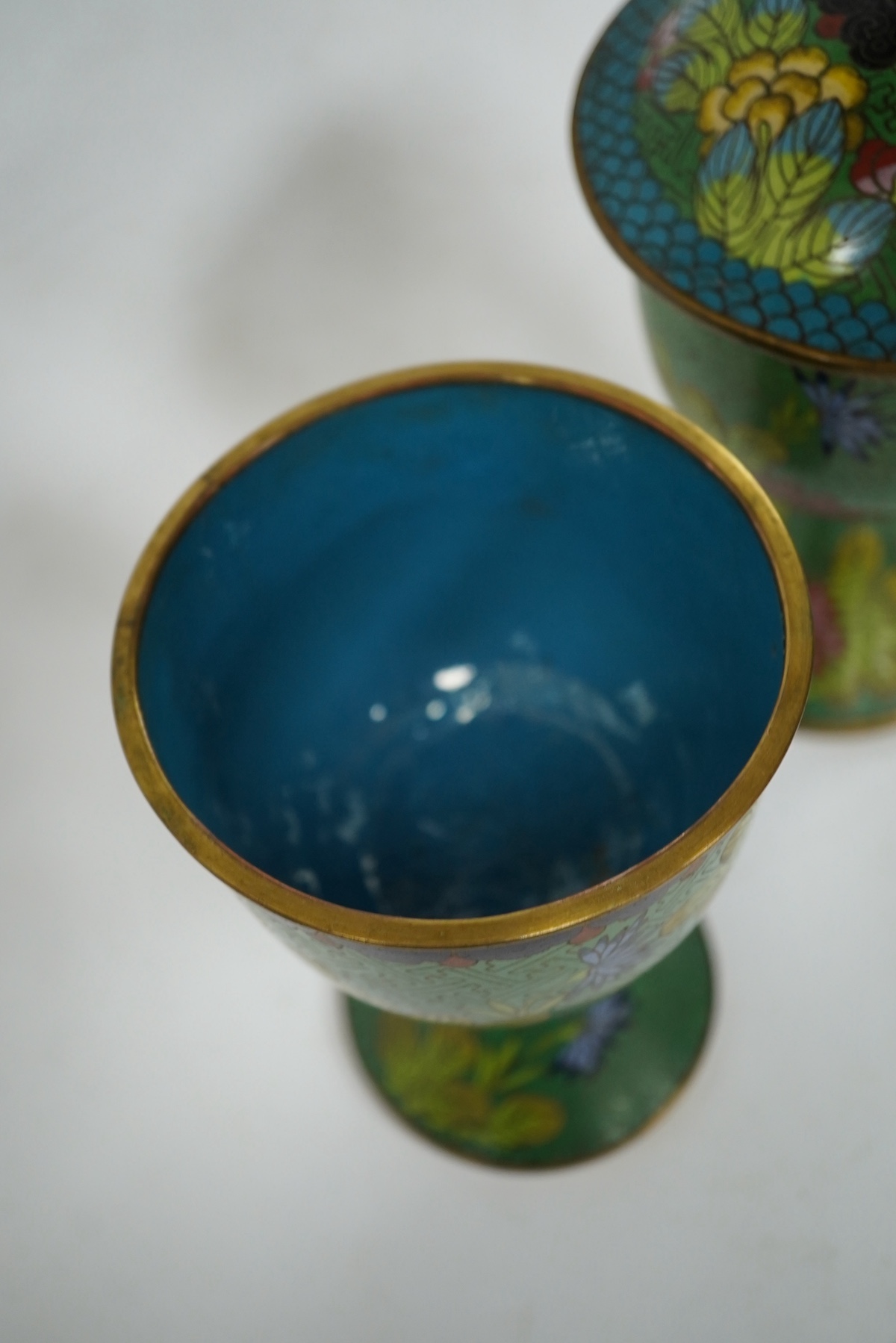 A pair of Chinese champleve enamel floral jars and covers, 22cm high. Condition - good